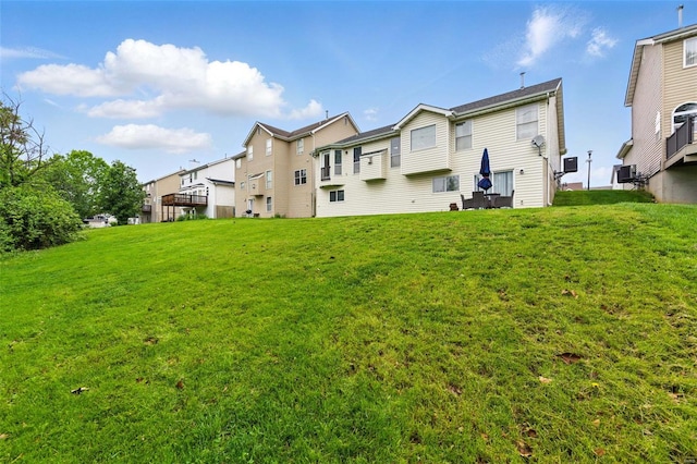 rear view of house featuring a lawn and a residential view
