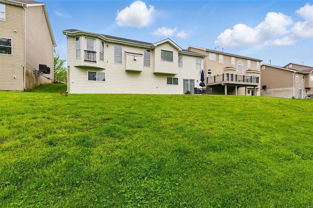 back of property featuring a lawn and a residential view