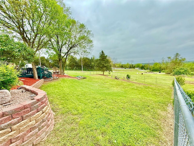 view of yard with fence and a playground