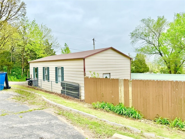 view of side of home featuring fence