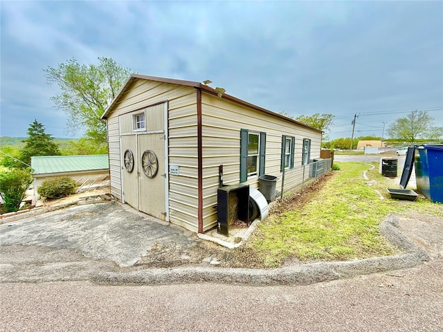 view of property exterior with an outdoor structure