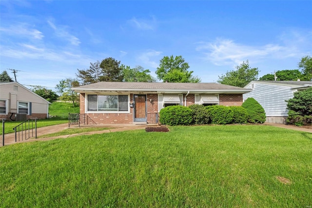 ranch-style home featuring brick siding and a front lawn