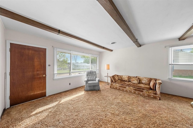 living area with carpet and beam ceiling