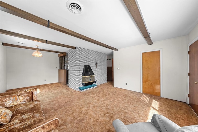 carpeted living area featuring a large fireplace, beamed ceiling, and visible vents