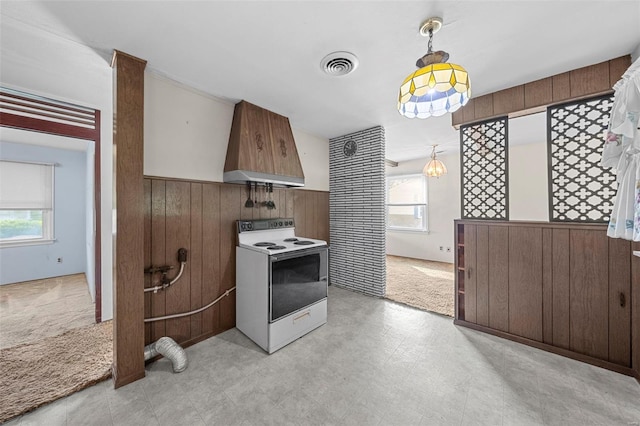 kitchen featuring wood walls, a wainscoted wall, custom range hood, visible vents, and white electric stove