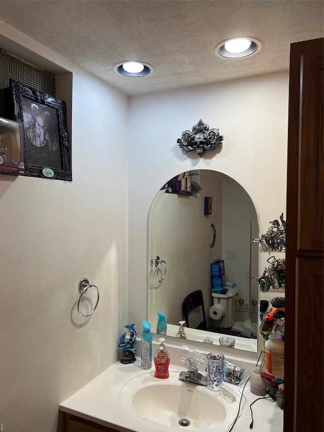 bathroom featuring vanity and a textured ceiling