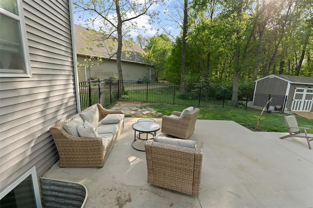 view of patio featuring an outdoor structure, outdoor lounge area, a fenced backyard, and a storage unit