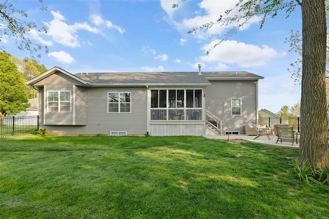 back of property featuring a sunroom, a patio area, fence, and a yard