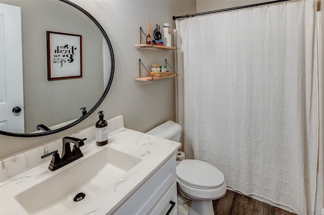 bathroom with vanity, a shower with shower curtain, wood finished floors, and toilet