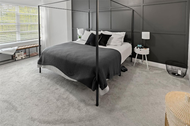 bedroom with carpet flooring and a decorative wall