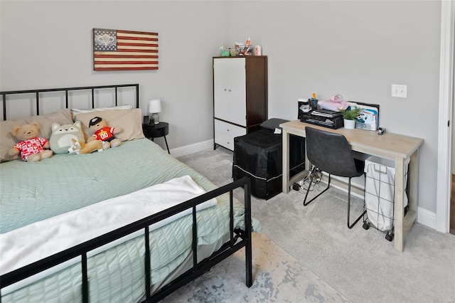 bedroom featuring baseboards and carpet