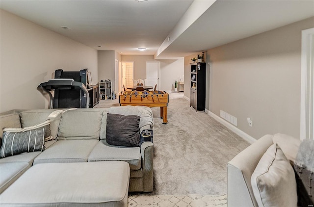 living area with baseboards, light carpet, and visible vents
