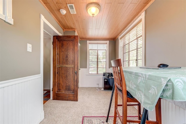 bedroom featuring wooden ceiling, wainscoting, carpet, and crown molding