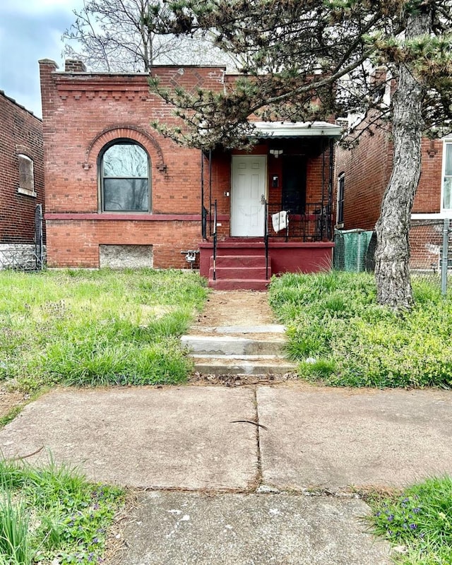 view of front of property featuring covered porch and brick siding