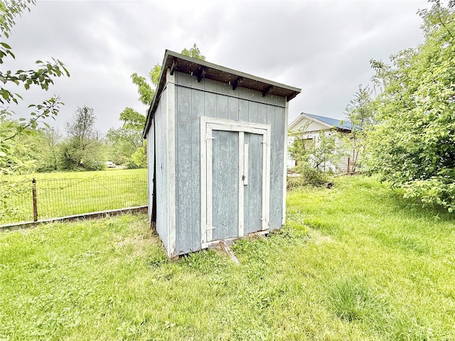 view of shed featuring fence