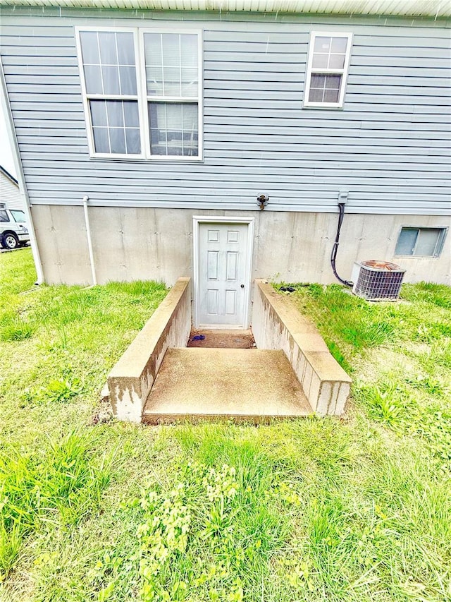 property entrance featuring central AC unit