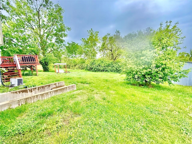 view of yard with a deck and stairs