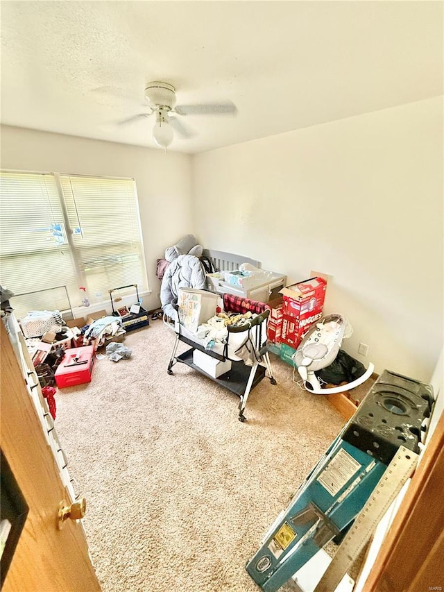 carpeted bedroom featuring a ceiling fan