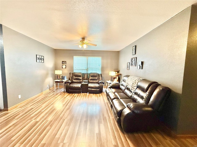 living area with wood finished floors and ceiling fan