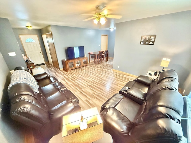 living area with ceiling fan, wood finished floors, and baseboards