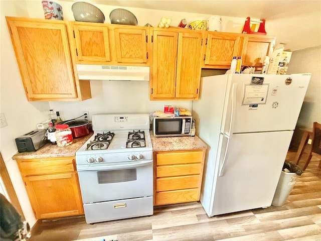 kitchen with white appliances, light wood finished floors, and under cabinet range hood