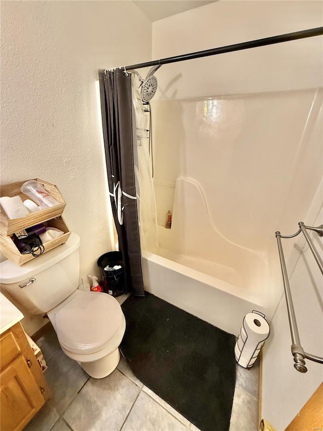 full bath with tile patterned floors, a textured wall, toilet, and shower / tub combo with curtain