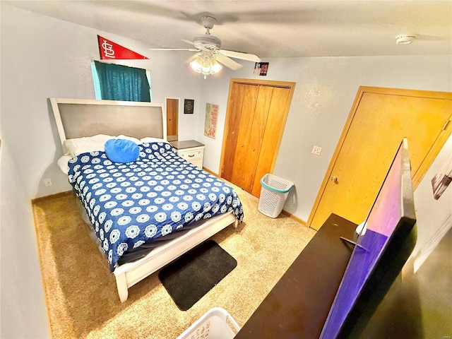 bedroom featuring a ceiling fan, a closet, carpet floors, and baseboards