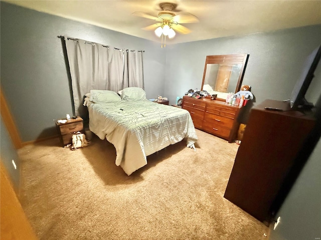 bedroom with a ceiling fan and light colored carpet