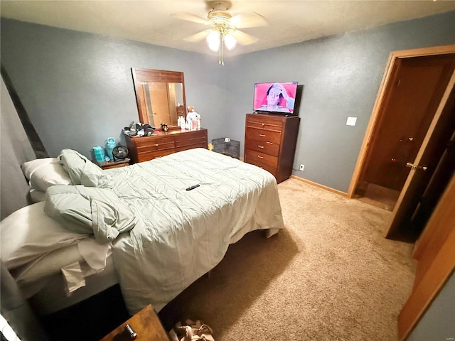 bedroom featuring a ceiling fan, carpet, and baseboards