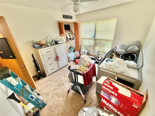 interior space with a ceiling fan and light carpet