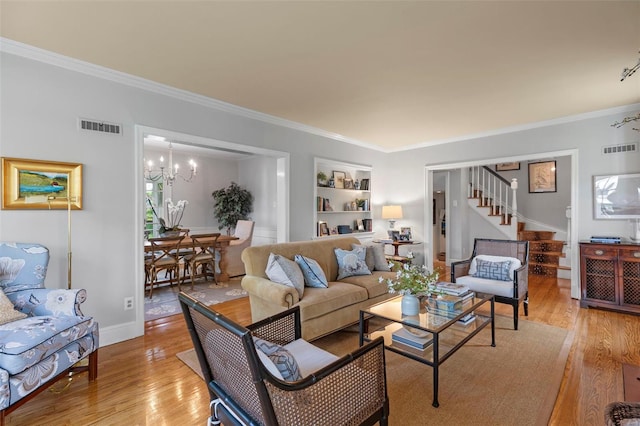 living room featuring ornamental molding, visible vents, and light wood finished floors