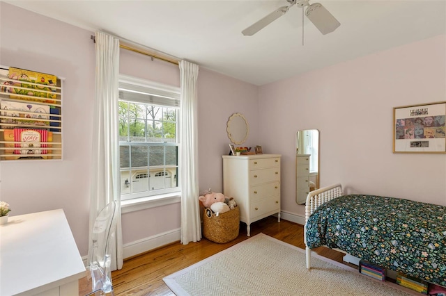bedroom featuring wood finished floors, ceiling fan, and baseboards