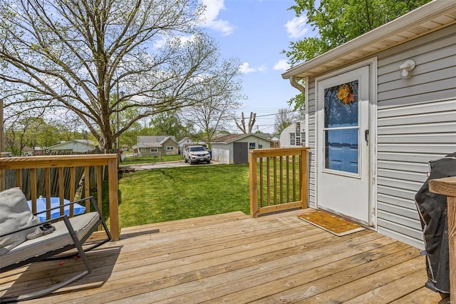 deck featuring an outbuilding and a yard