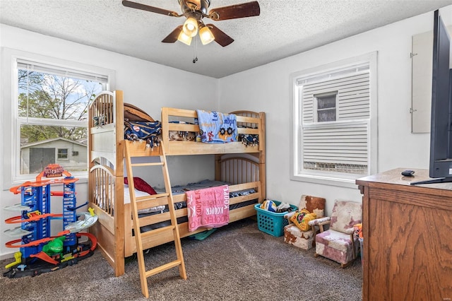 bedroom featuring a textured ceiling, ceiling fan, and carpet floors