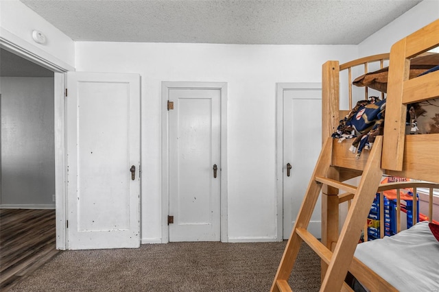 carpeted bedroom with a textured ceiling