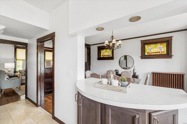 interior space featuring baseboards and a notable chandelier