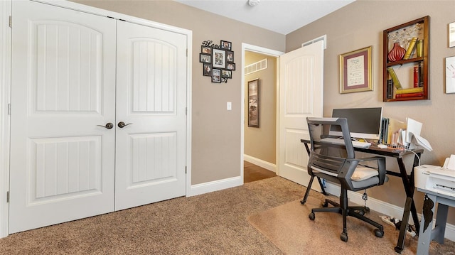 office featuring baseboards, visible vents, and carpet
