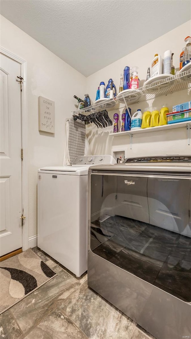 laundry room featuring separate washer and dryer and laundry area