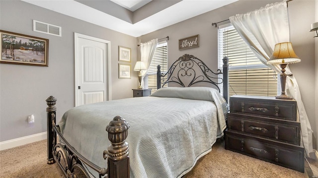 carpeted bedroom featuring a closet, visible vents, and baseboards