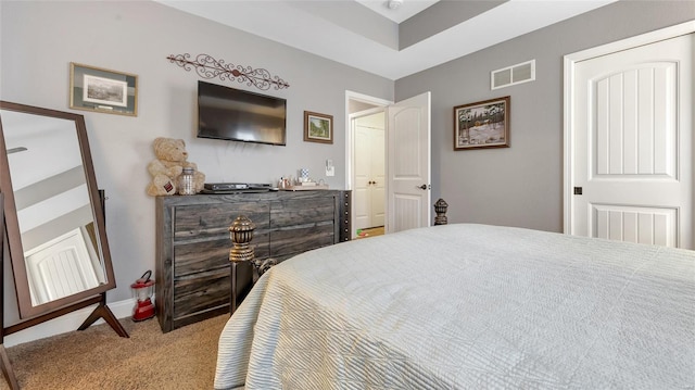 carpeted bedroom featuring visible vents and baseboards