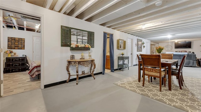 dining area with concrete flooring and baseboards