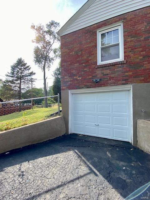 garage with aphalt driveway