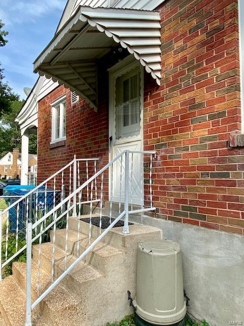 property entrance with brick siding