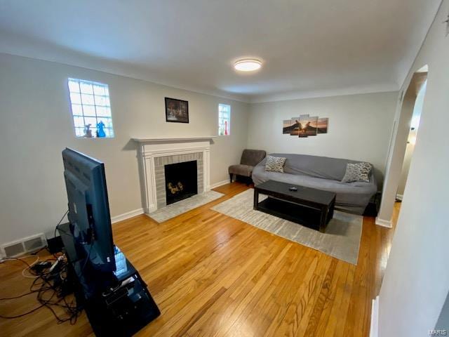 living room featuring visible vents, wood finished floors, and plenty of natural light