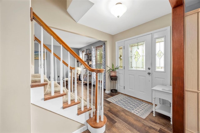 foyer with wood finished floors and stairs