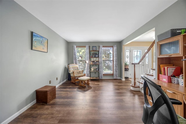 sitting room featuring wood finished floors, stairs, and baseboards