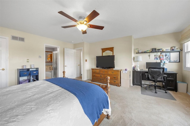carpeted bedroom featuring a ceiling fan and visible vents