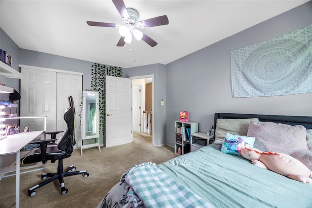 bedroom with a closet, a ceiling fan, baseboards, and light carpet