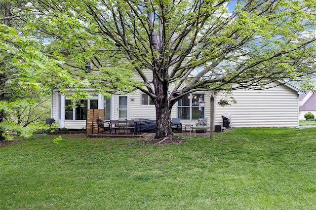 rear view of house with a yard and a patio