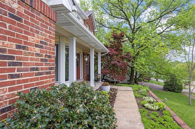 view of side of property featuring a yard and brick siding